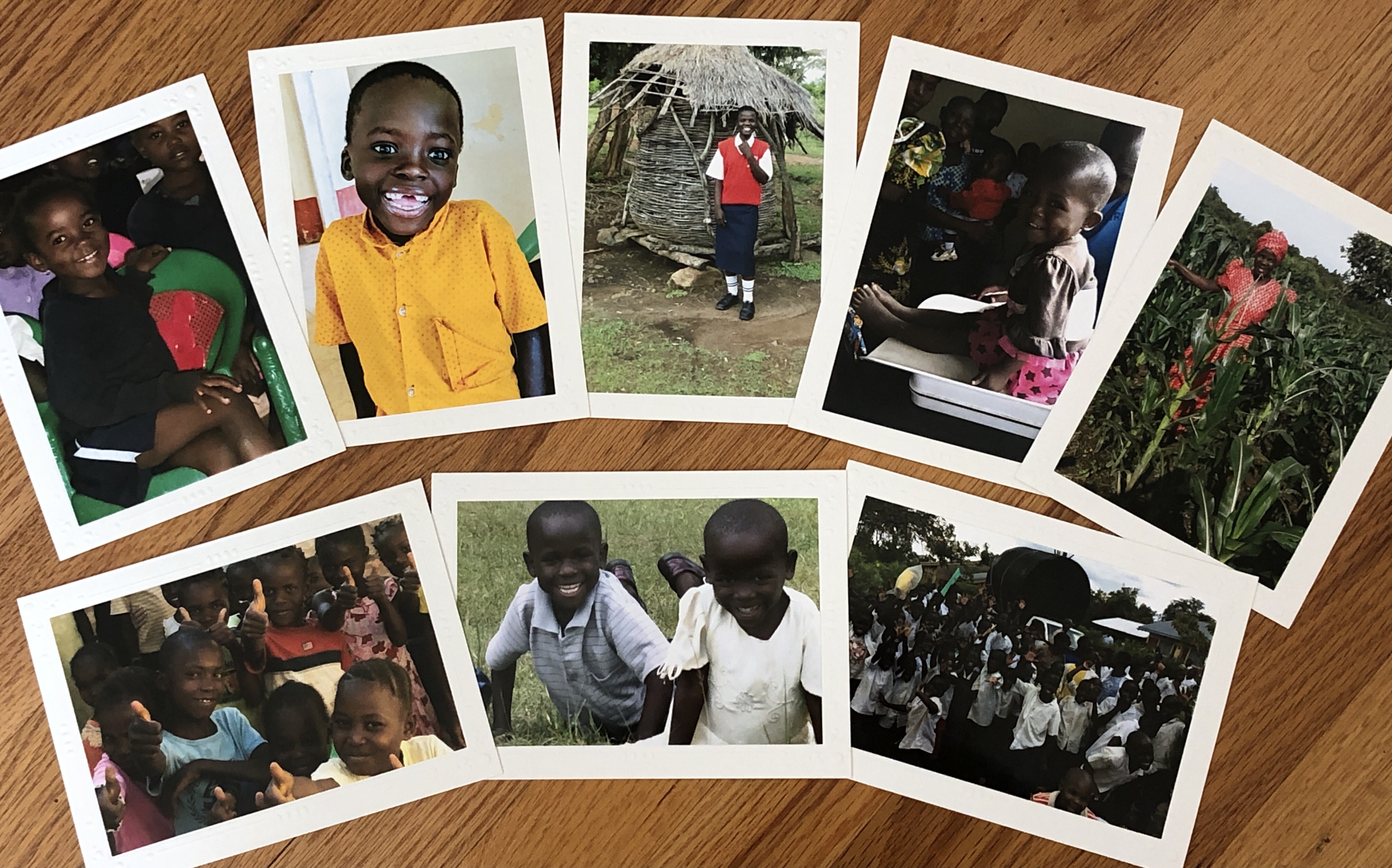 Only 12 card packages are still available. Photos of adorable children, students and farmers smile at your from each card. A set of eight cards with envelopes is $25.