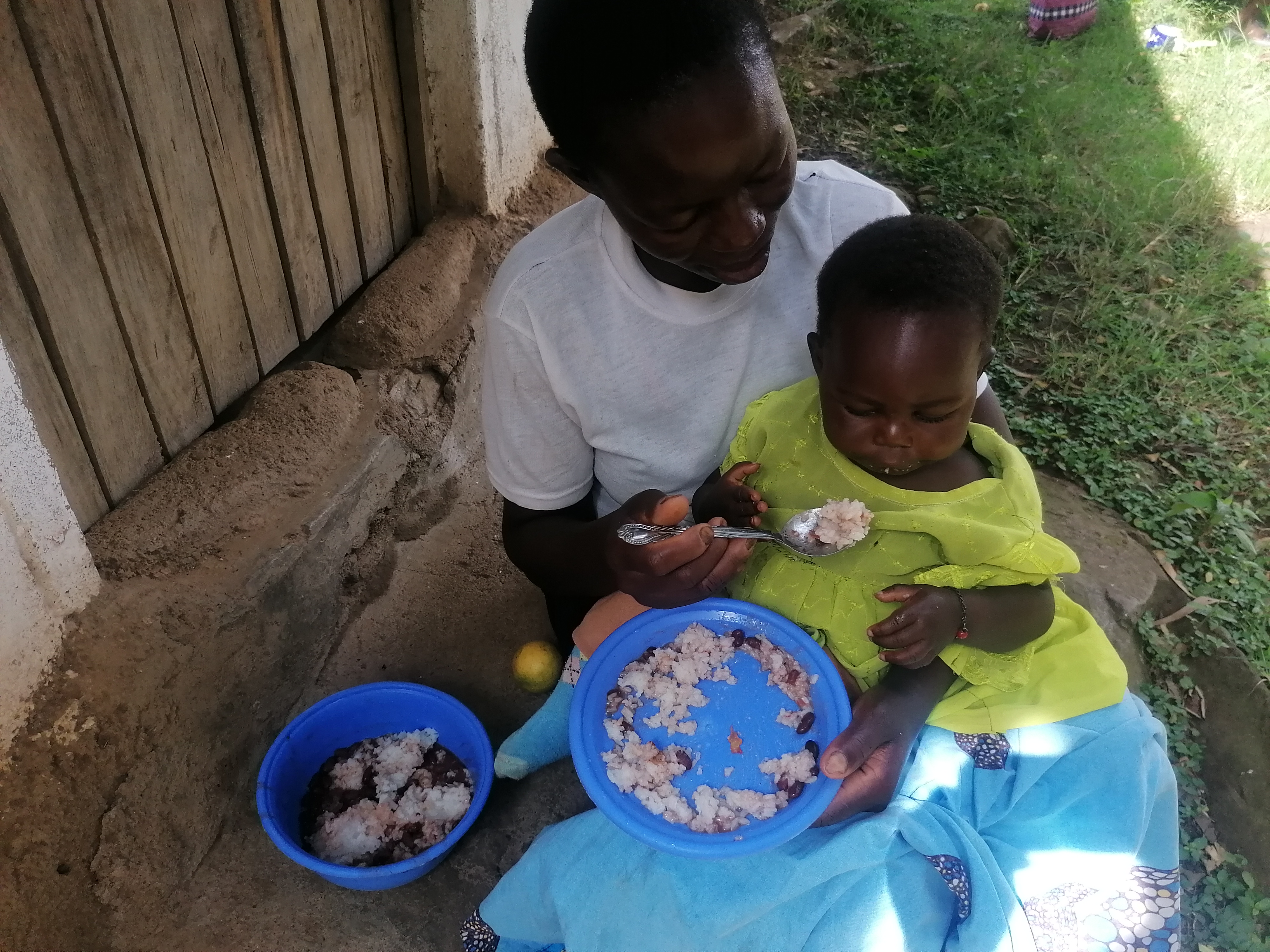 Mary Aoko having her meal with her mother Ruth during the weekly POM meetings